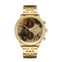 Mahogany Rose M watch features a gold-tone metal band and floral dial with roses and leaves, displaying intricate details.