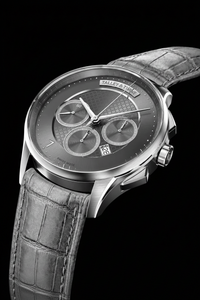 Talley & Twine Luxury watch with a dark face and gray leather strap on a black background
