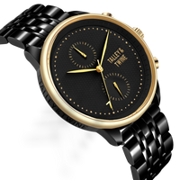 Pharaoh watch with a black dial, gold accents, and a black metal bracelet, displayed at an angle.