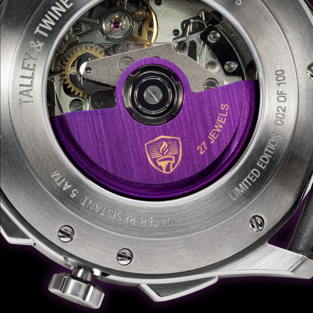 Close-up of a watch mechanism with purple gemstone and brand name 'Talley & Twine'.