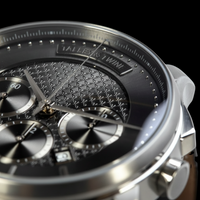 Talley & Twine Close-up of a silver watch with detailed face on a black background